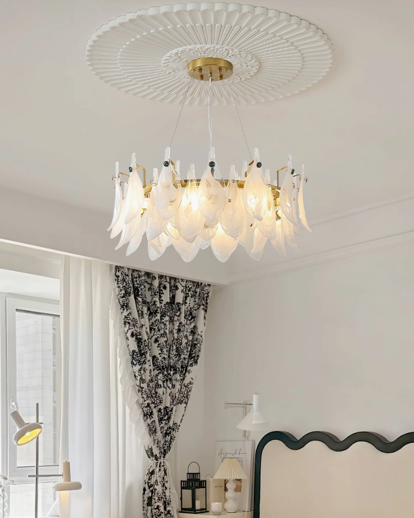 Round petal glass chandelier installed in French style bedroom with patterned decor