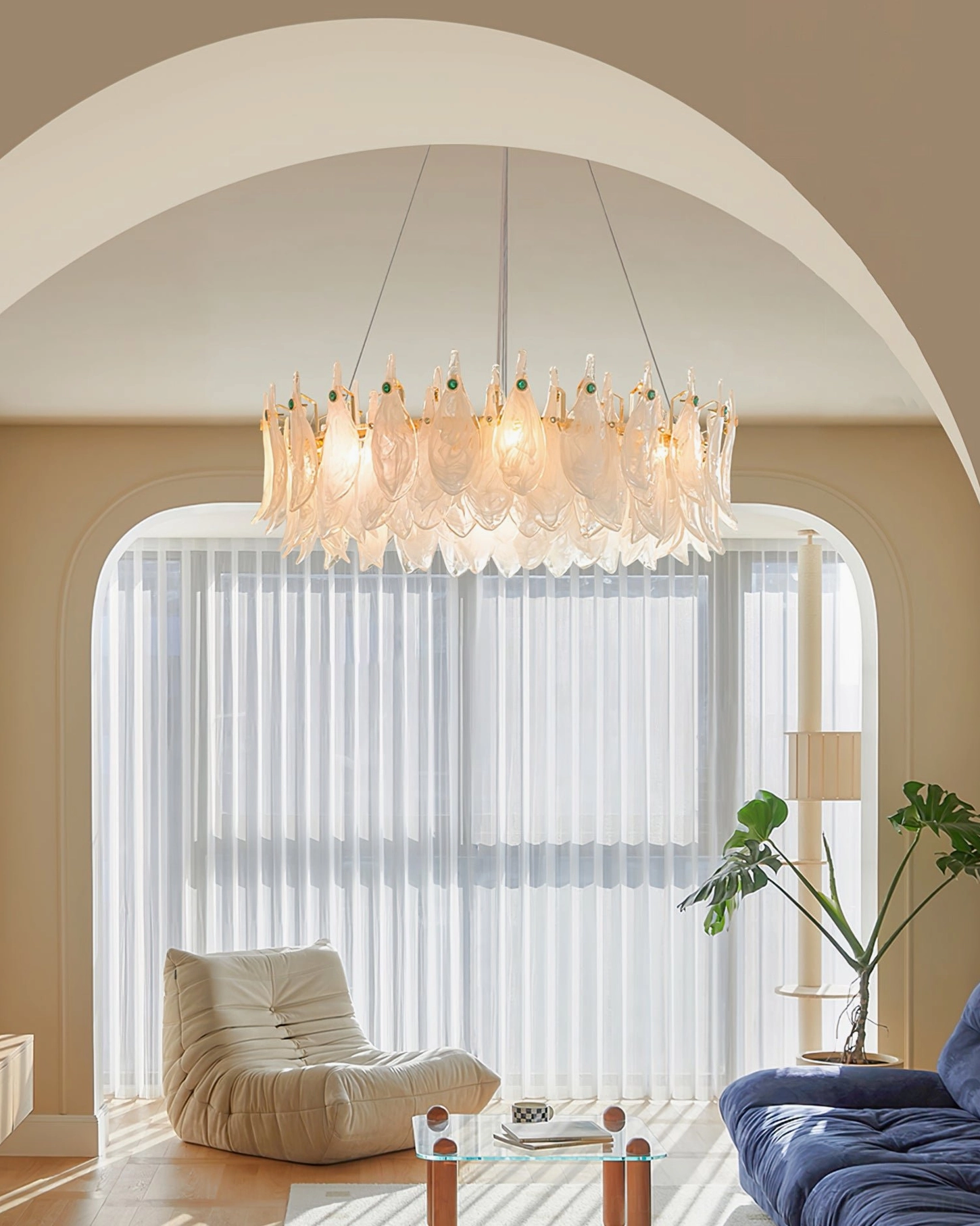 Cloud glass chandelier glowing above arched fireplace in French style interior design