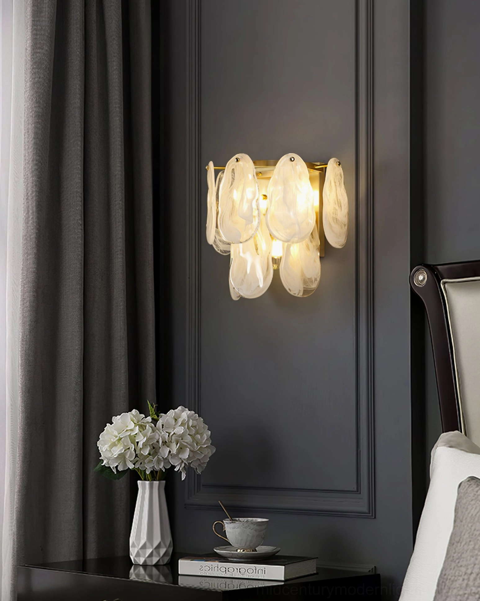 Cloud glass wall sconce in neoclassical style living room with floral table decor, front view showing warm glowing frosted glass shades