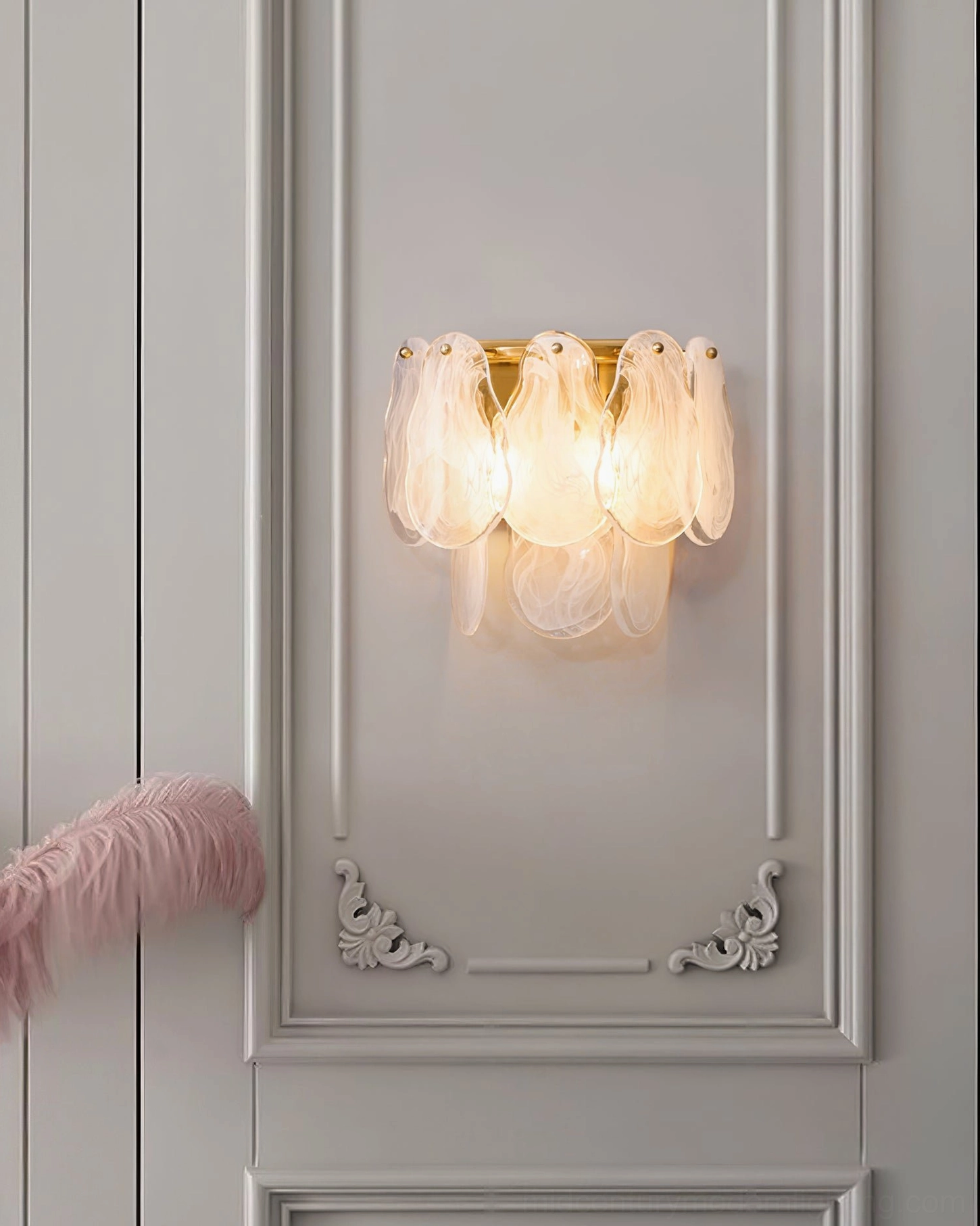 Cloud glass wall sconce mounted on white carved decorative wall with pink fur accent, soft warm light diffusion through frosted shades