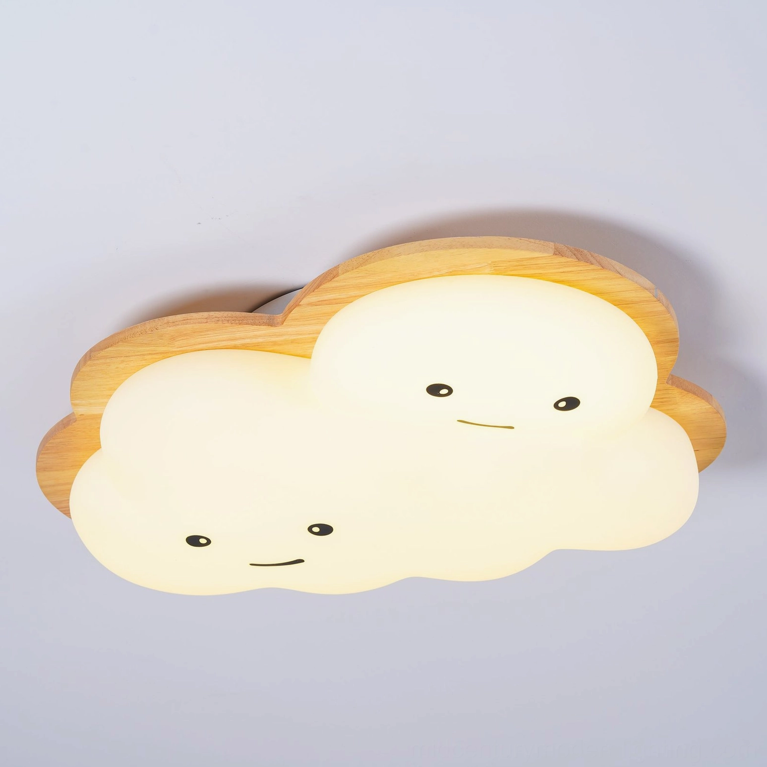 Close-up of smiling cloud lamp shade showing white acrylic diffuser and wood frame construction