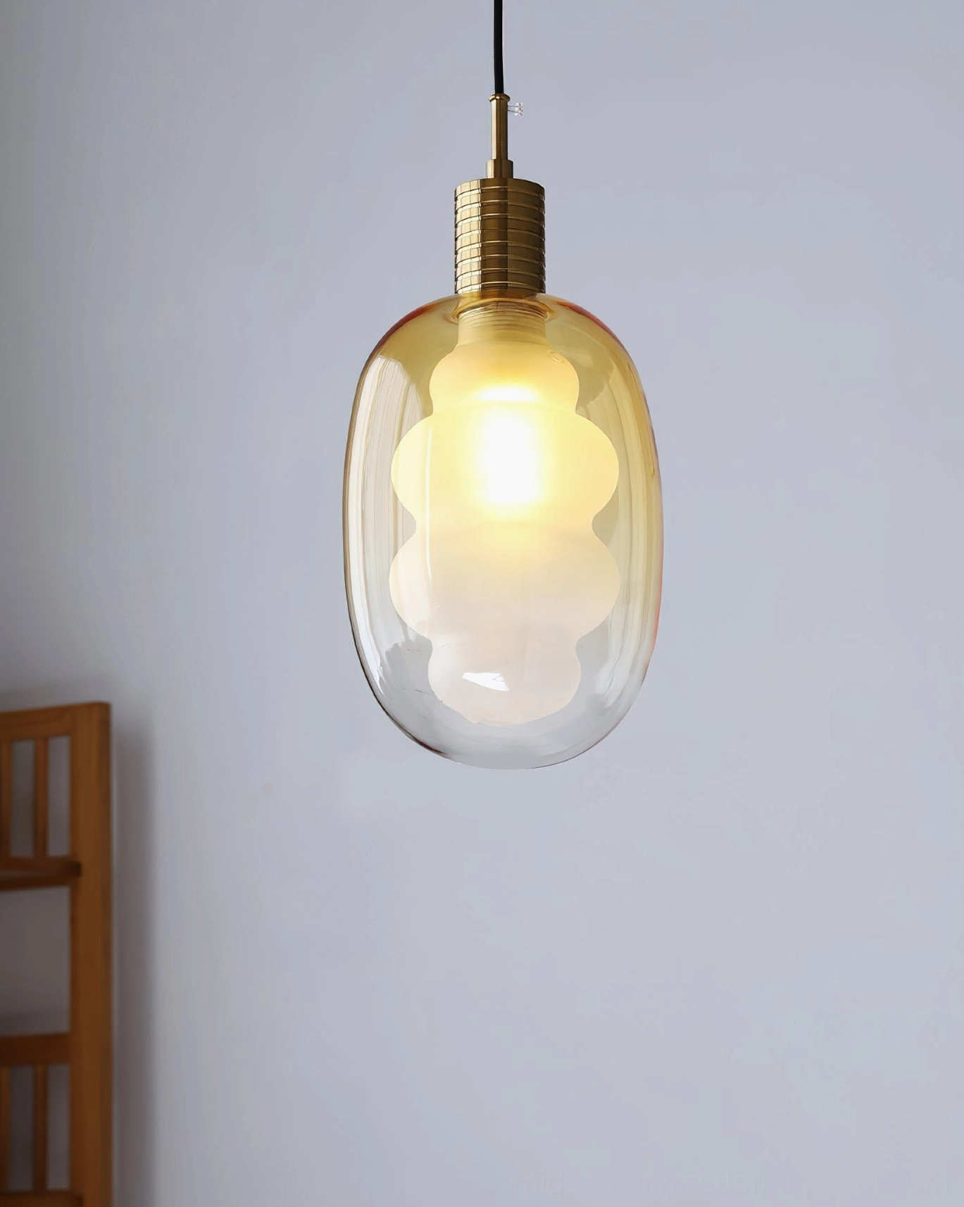 Sculptural pendant light with frosted cloud-shaped inner shade, gradient exterior glass, studio view