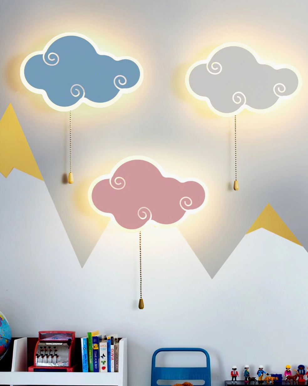 Set of three cloud wall lamps in blue, gray, and pink displayed in modern playroom with mountain wall decals