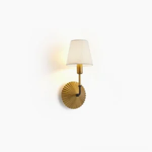 Clove brass wall lamp with pleated metal base and white fabric shade, front perspective view mounted on white wall, vintage luxury mid-century modern style