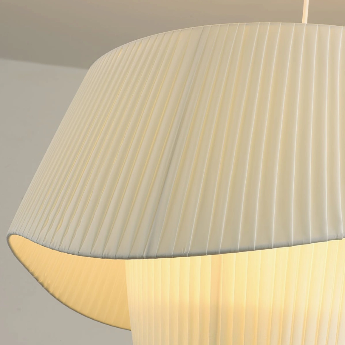 Coco pleated pendant lamp shadow play effect on ceiling from hand-wrapped plissé shade design