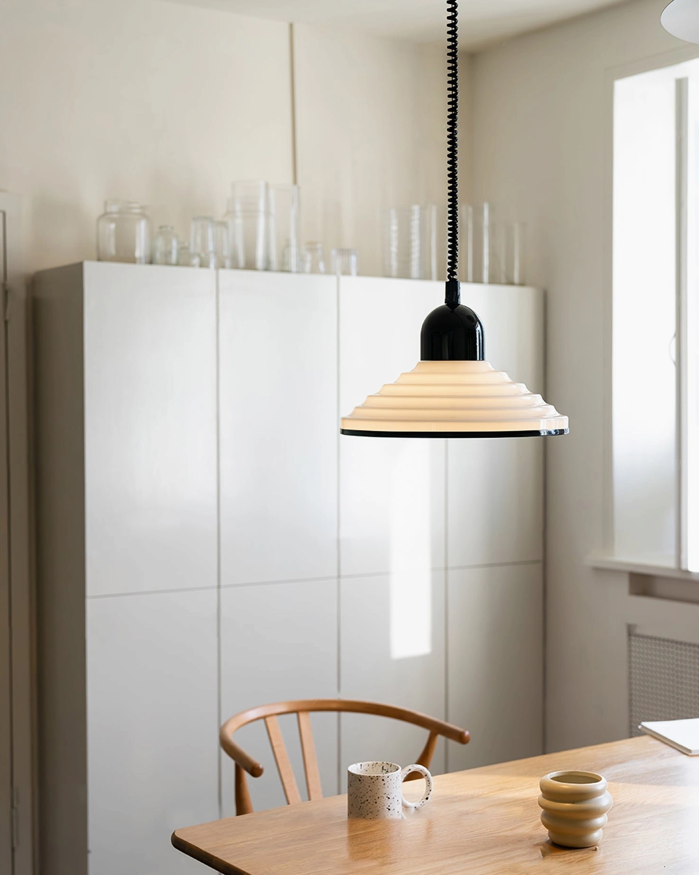 Modern minimalist ridged pendant lamp available in black and white color options