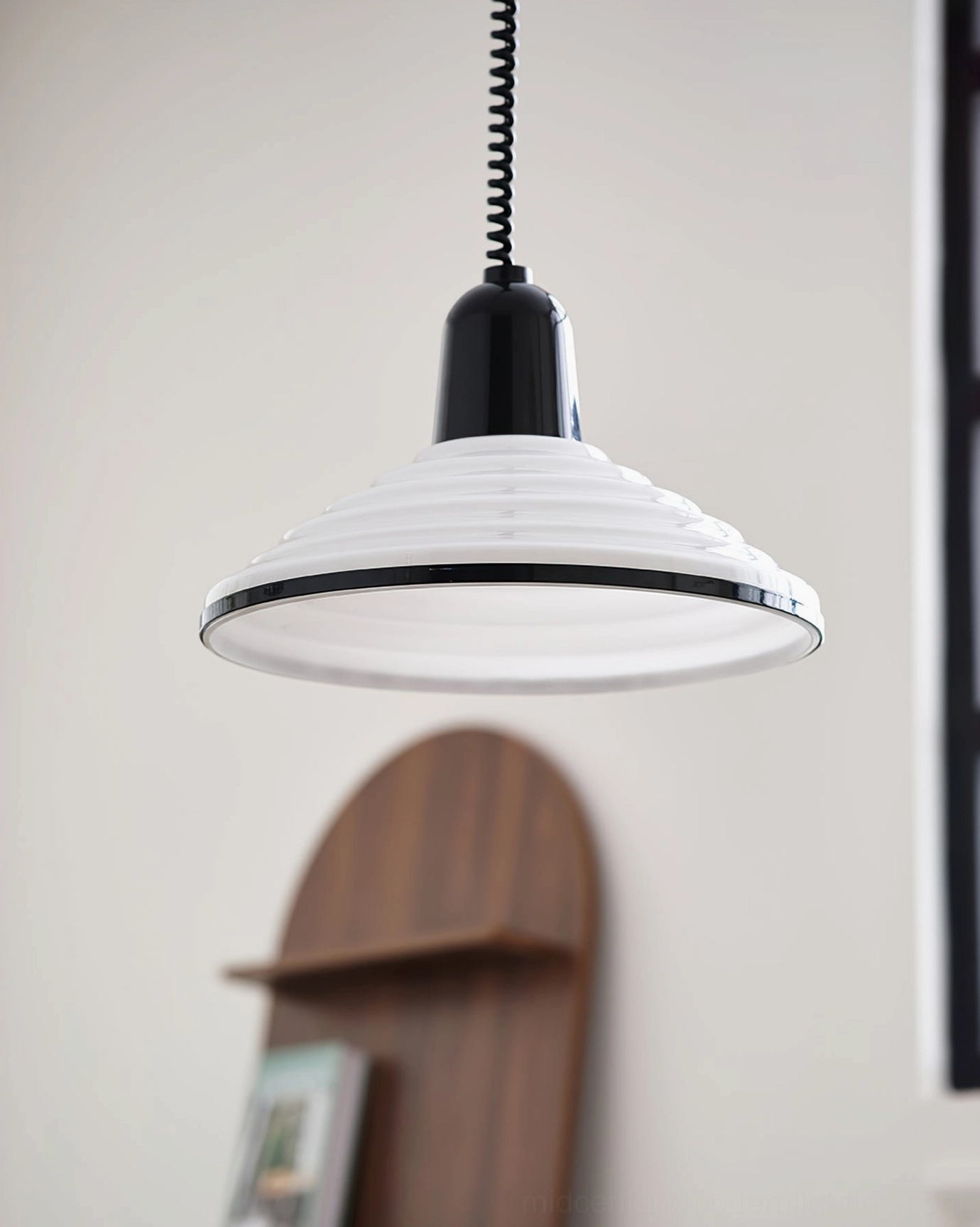 Glossy ridged pendant lamp overhead view bright interior space exposed bulb visible
