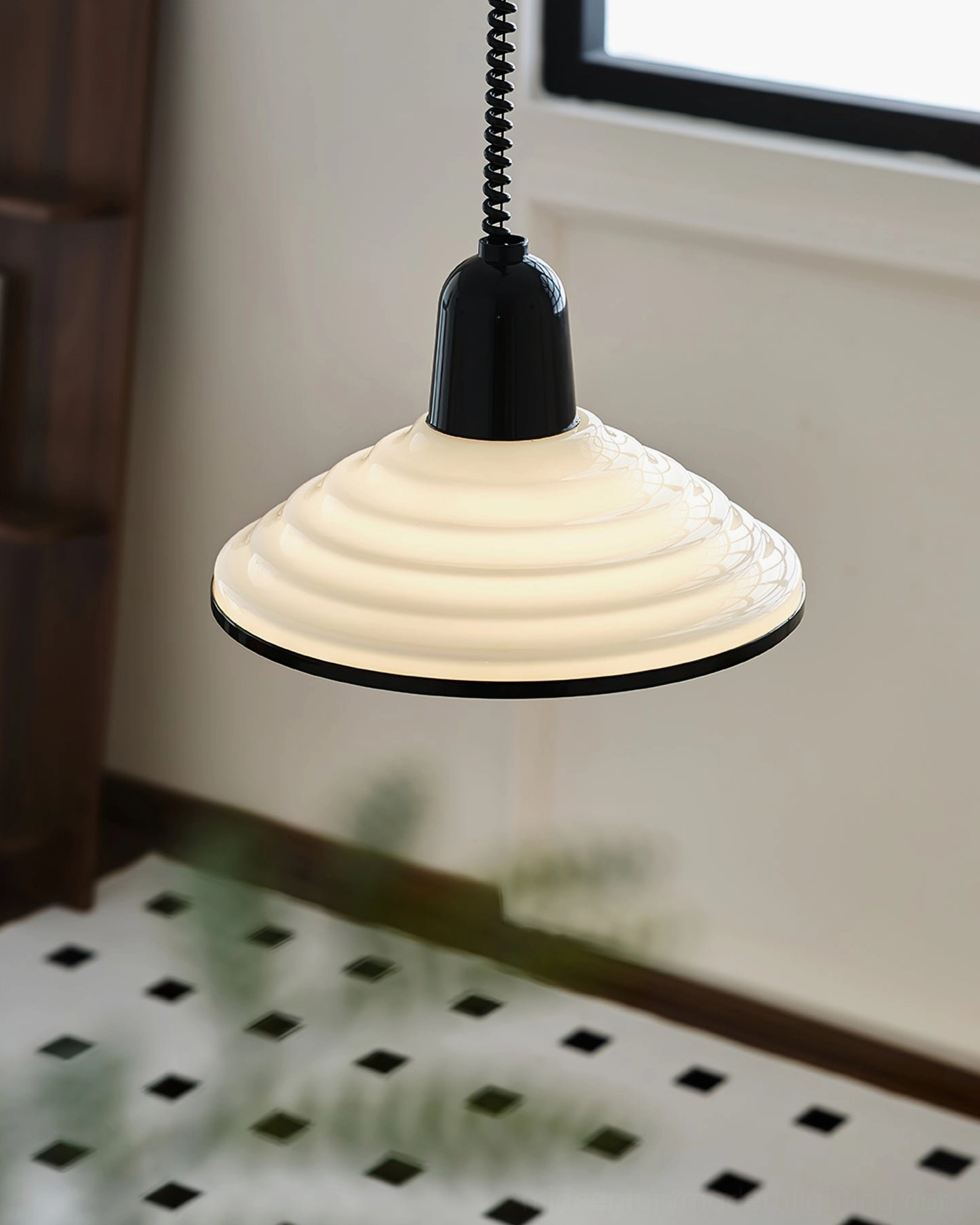 Warm-toned ridged glass pendant light low angle view on checkered tile floor