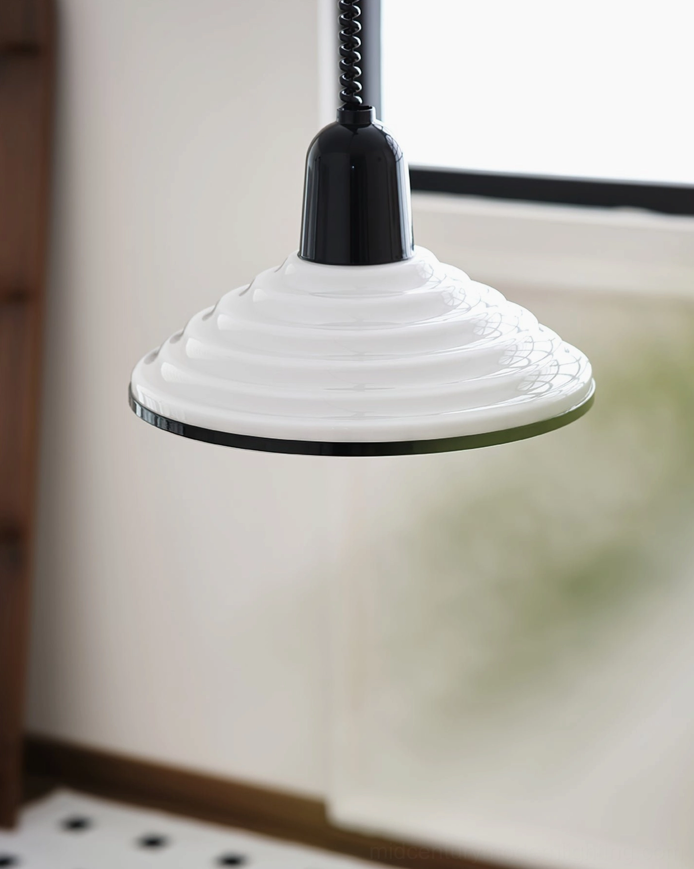 Striped ridged glass pendant lamp with black trim edge overhead window-side view