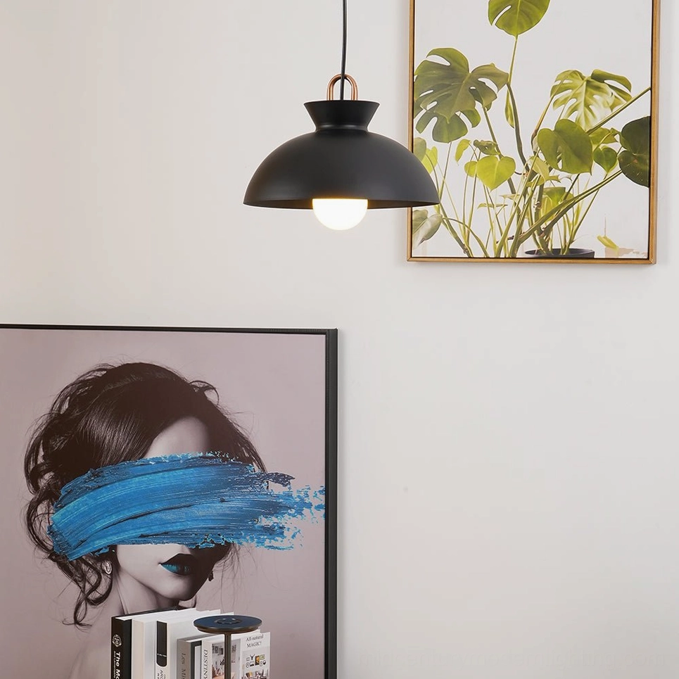 Black matte coil pendant light with exposed filament bulb in industrial modern setting