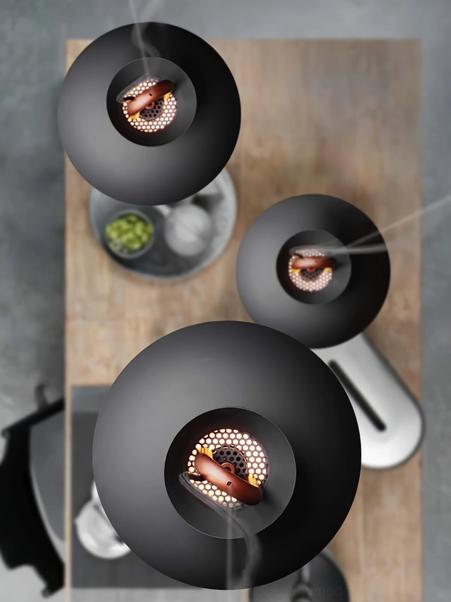 Black coil round pendant lamp overhead view showing exposed internal hardware and design