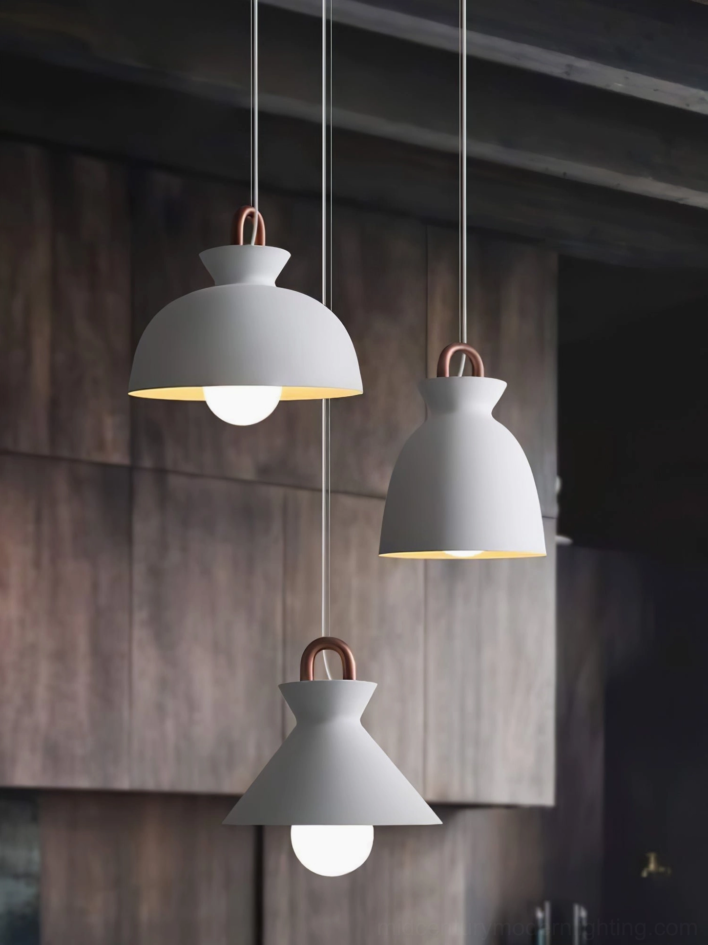 Coil pendant light with copper-toned suspension hardware in scandinavian interior