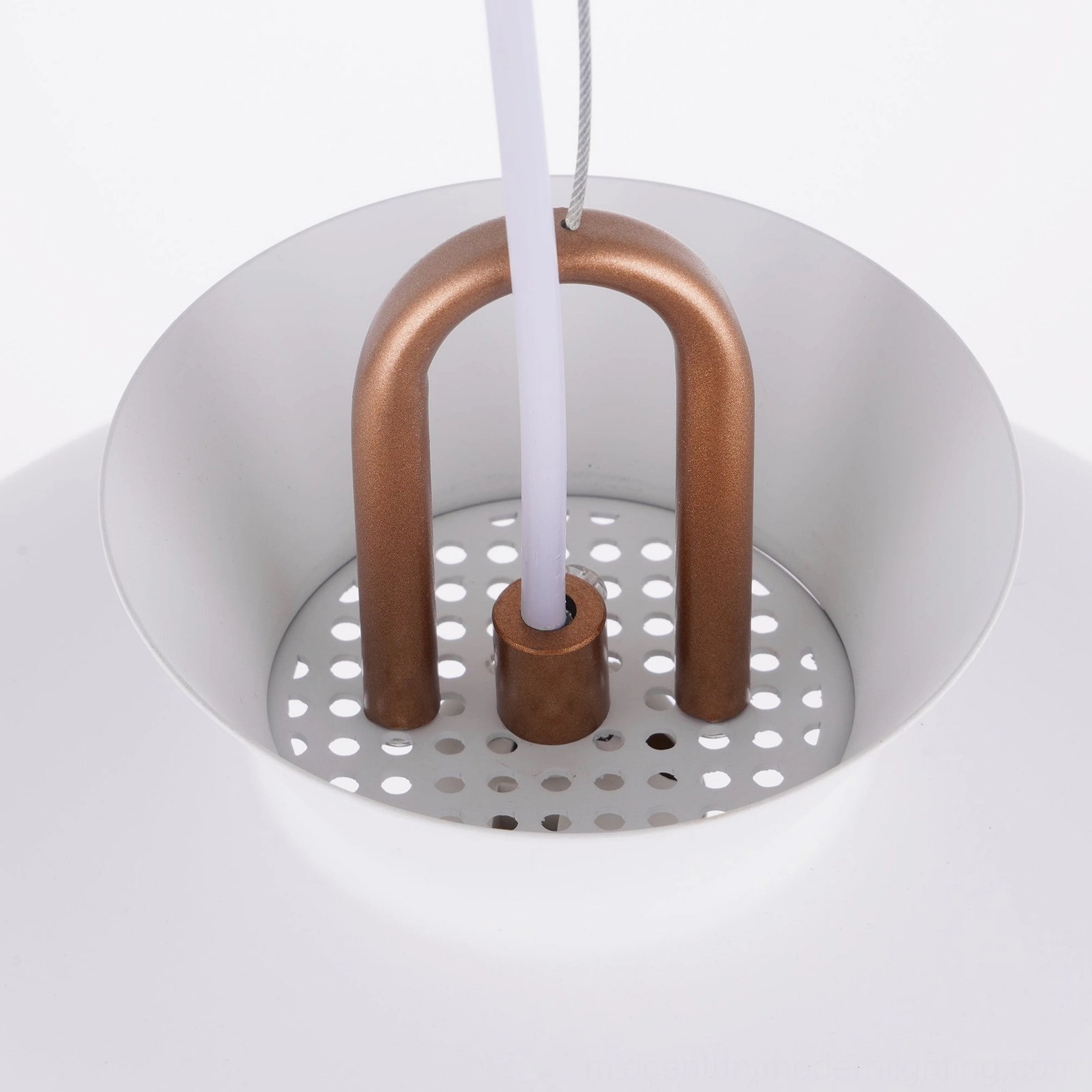 Coil pendant light fixture detail showing copper suspension mechanism and matte finish