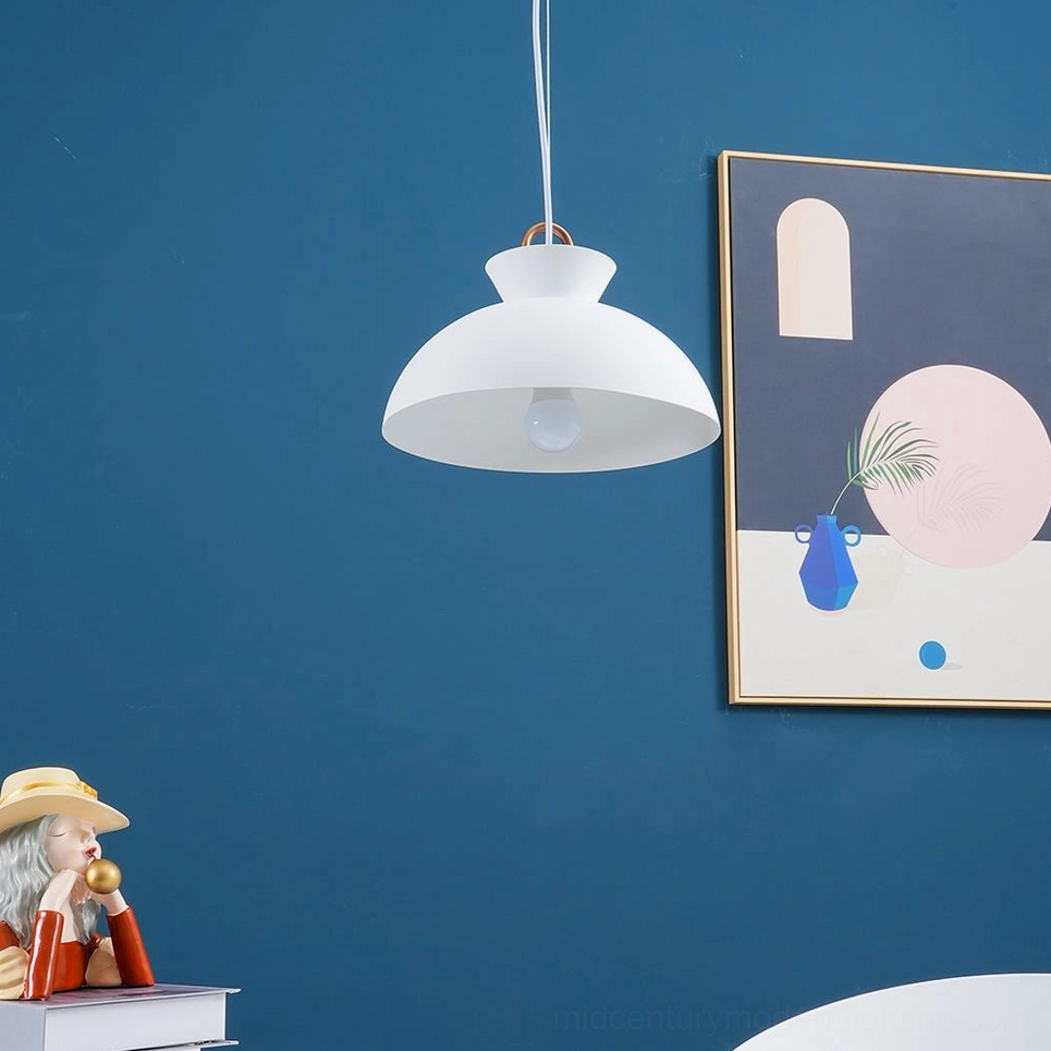 White matte coil dome pendant lamp suspended in dark blue modern interior space