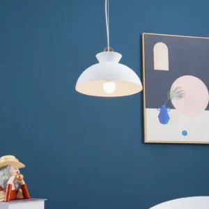 White matte coil pendant lamp hanging in contemporary living room with blue accent wall