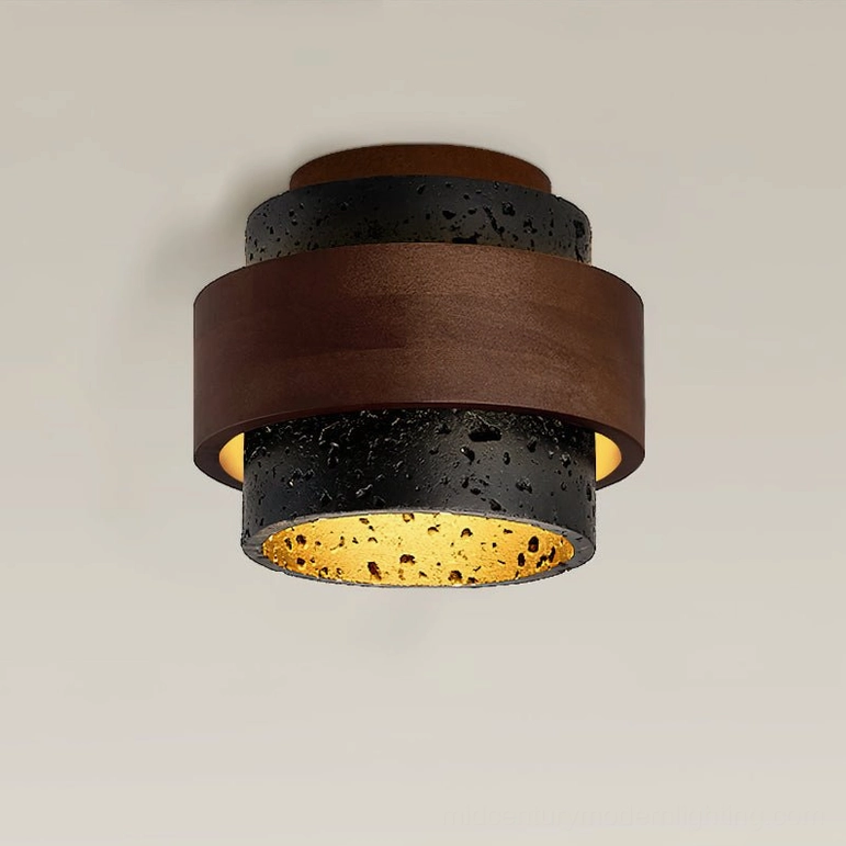 Cole Travertine ceiling light side close-up showing warm inner lighting and porous dark stone texture