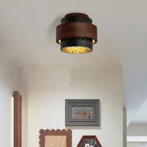 Cole Travertine modern ceiling light installed in vintage entryway with warm ambient glow and minimalist wall decor