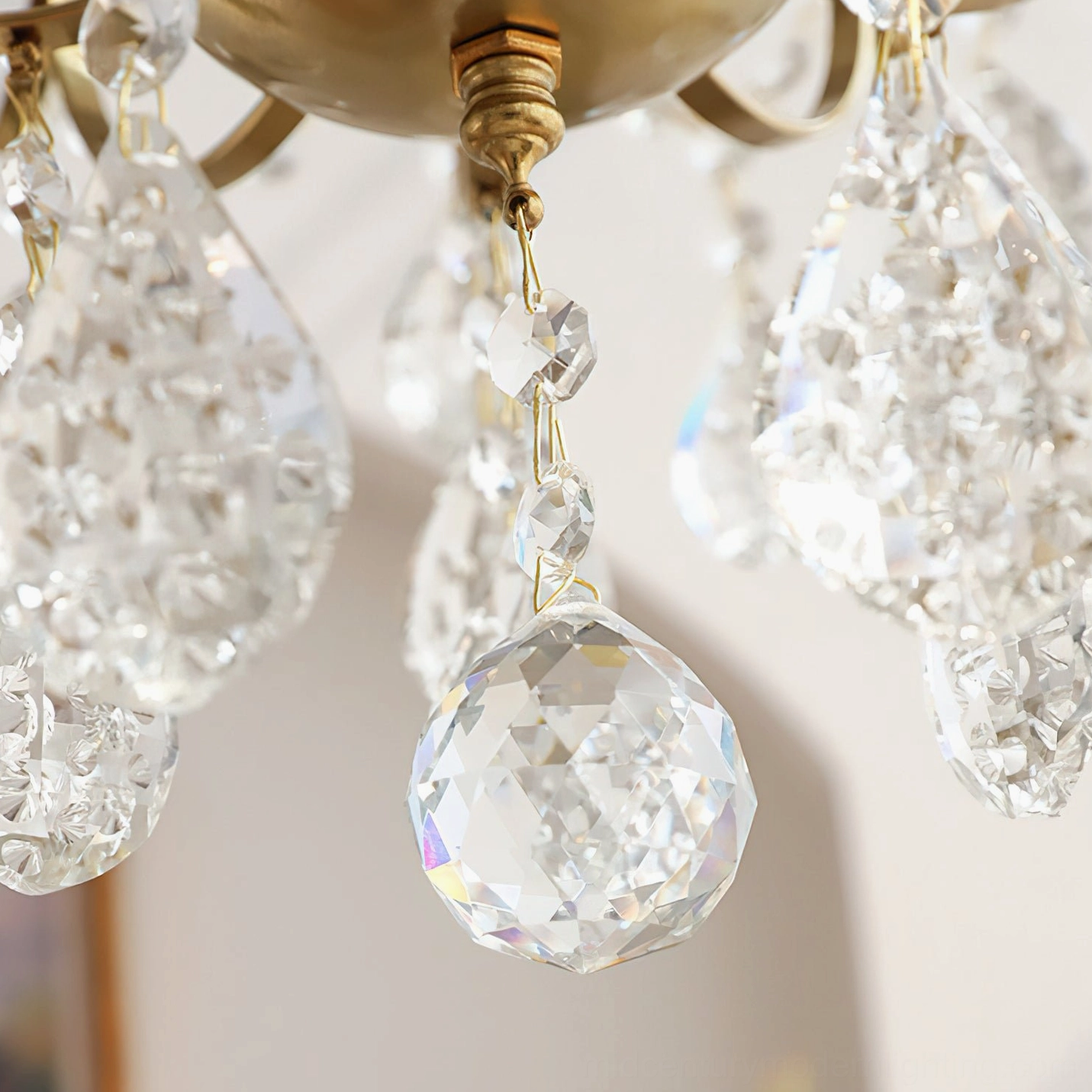 Colette Crystal Chandelier suspended in modern dining space with contemporary furniture and design