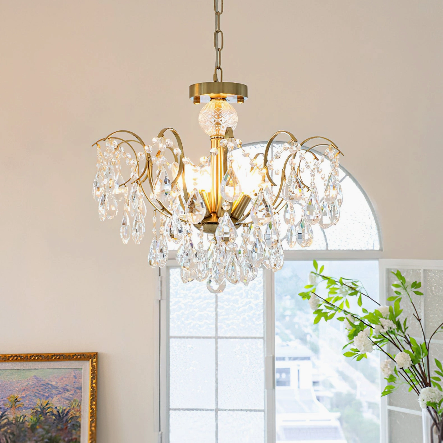 Colette Crystal Chandelier in residential space with arched window and vintage brass finish details