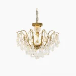 Colette Crystal Chandelier with polished brass frame and cascading faceted crystal prisms, front studio view