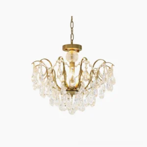 Colette Crystal Chandelier with polished brass frame and cascading faceted crystal prisms, front studio view