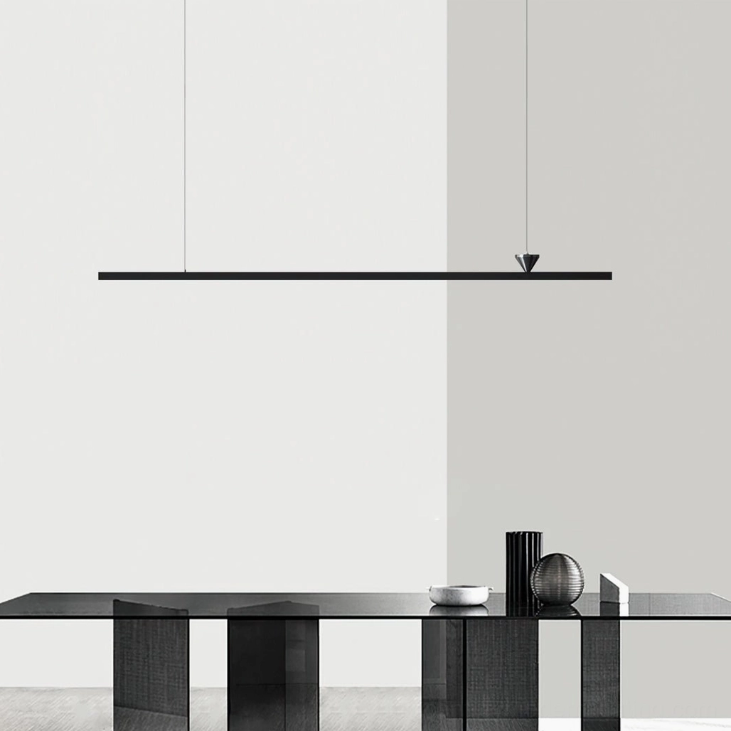 Black linear LED pendant light in minimalist interior with dark console table