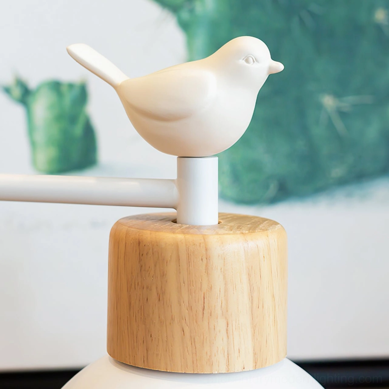 Colorato decorative bird ornament and wood junction detail on white metal pole