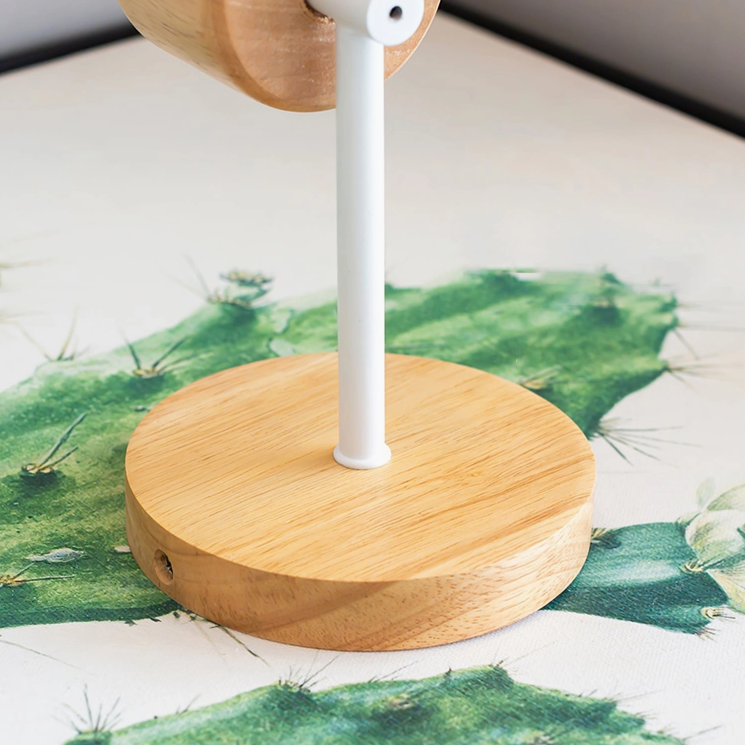 Close-up of Colorato bird sconce mounting hardware and natural wood shade assembly detail
