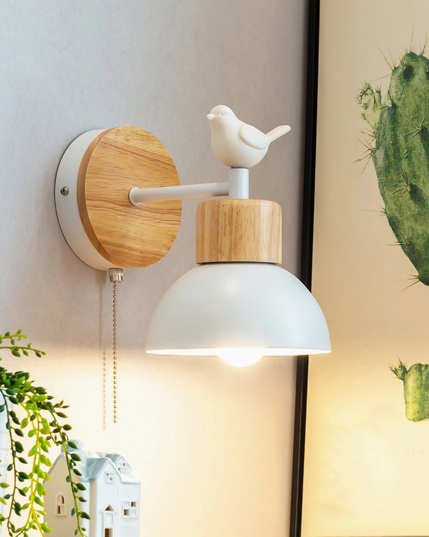 Colorato bird wall sconce installed beside green plant, showcasing minimalist Scandinavian interior design