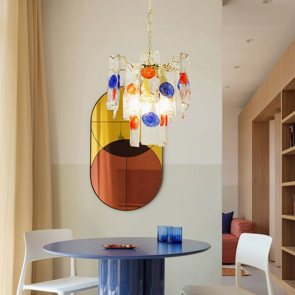 Artisan pendant lamp suspended above dark blue round dining table in residential dining room interior setting