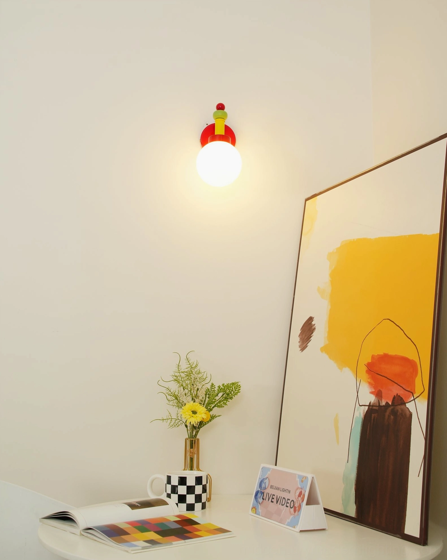 Colorful glass wall sconce with metal connectors and creative geometric styling showcase