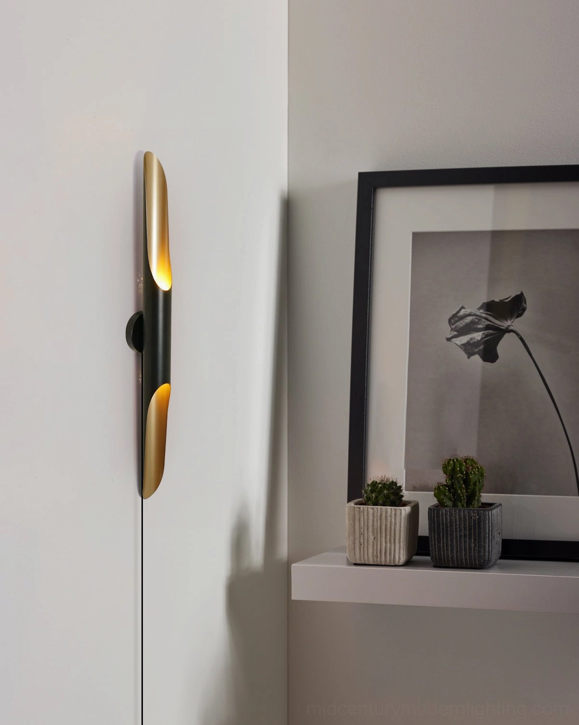 Coltrane wall sconce close-up angle, black and brass finish sleek minimalist shelf nook