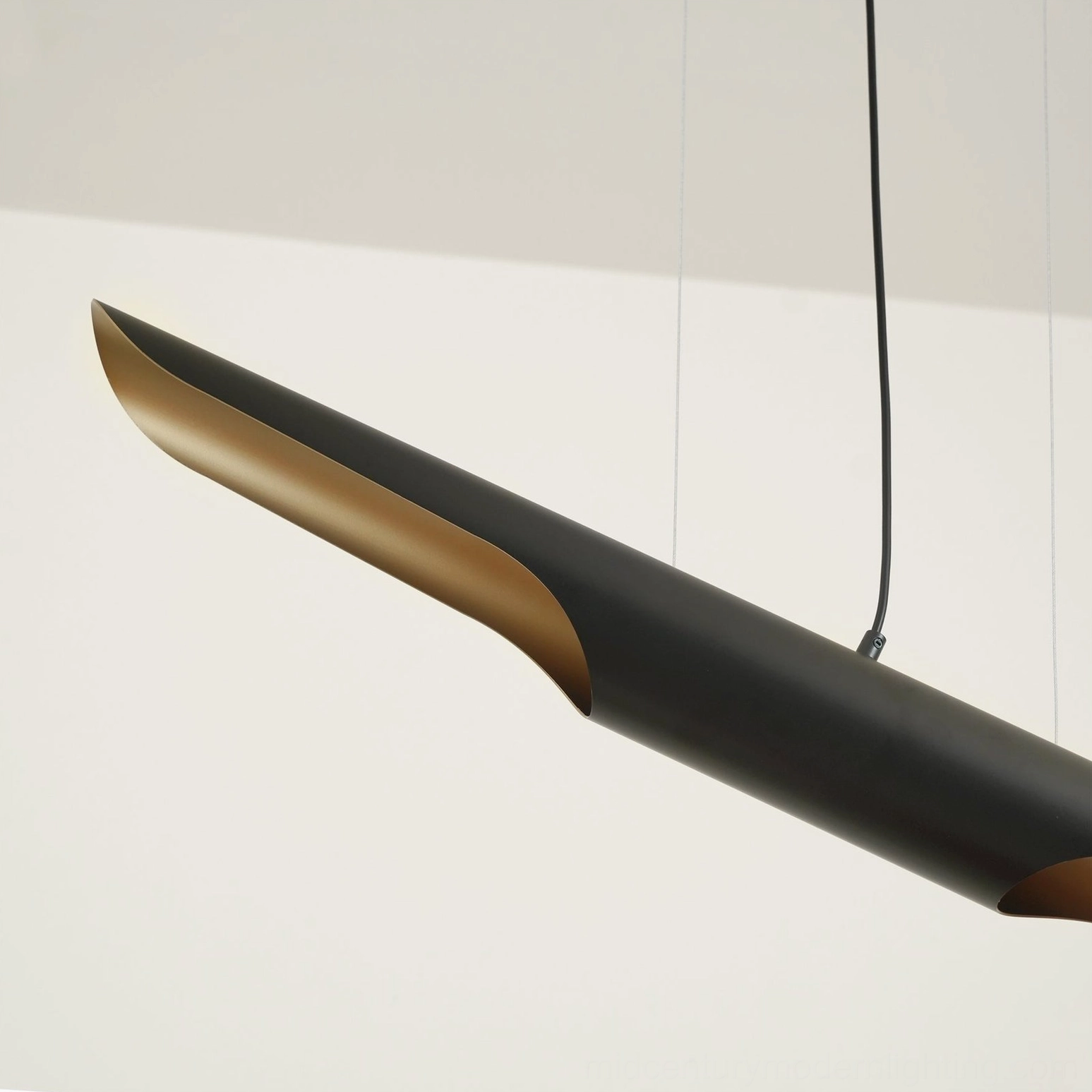 Side close-up view of Coltrane suspension lamp showing black exterior and glowing gold interior