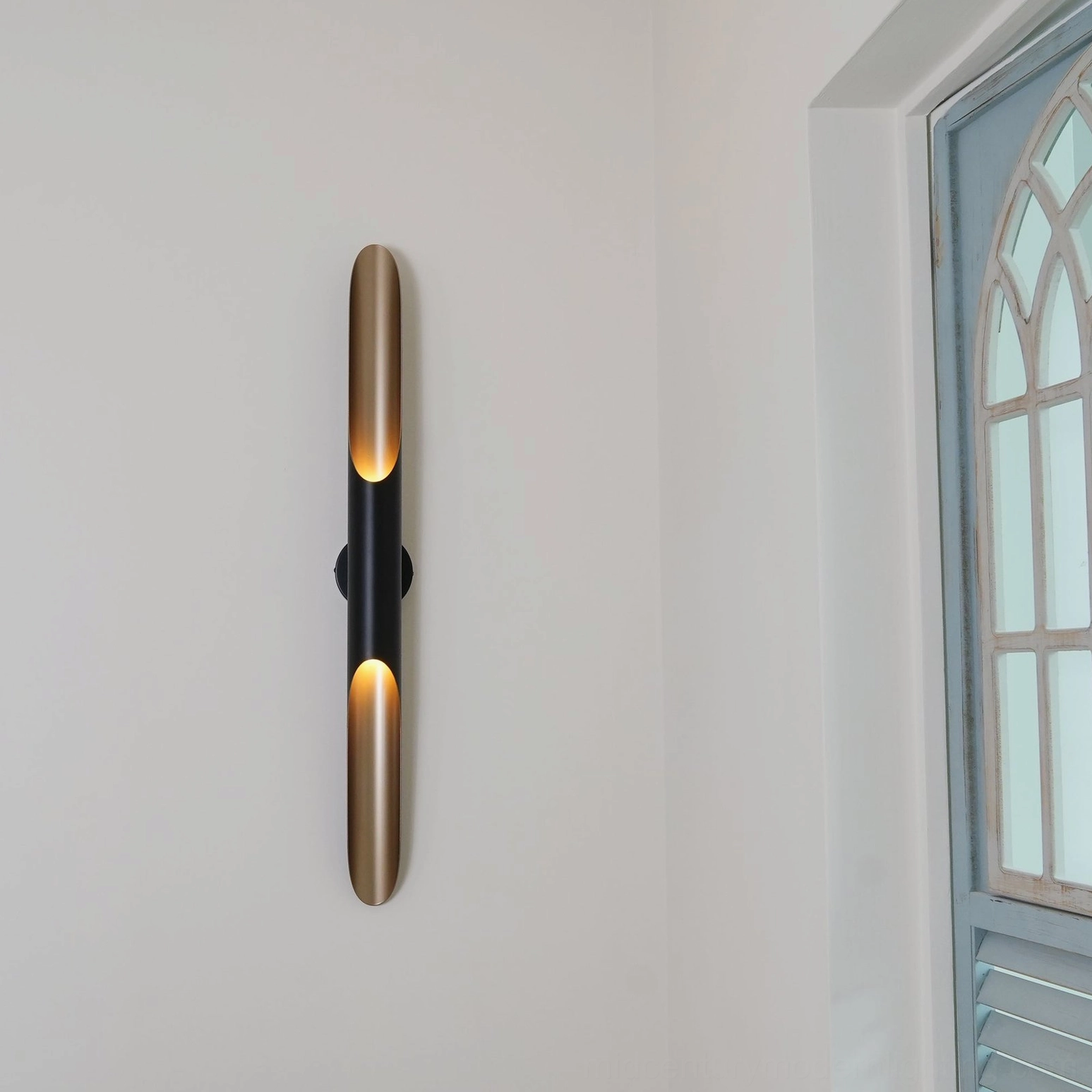 Coltrane modern wall sconce detail showing matte black exterior and warm light emission