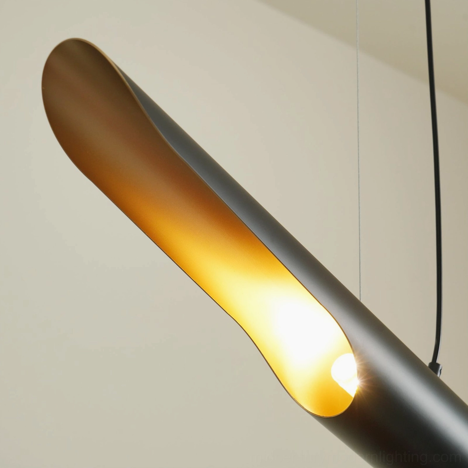 Extreme close-up of Coltrane pendant light interior showing illuminated gold surface and construction