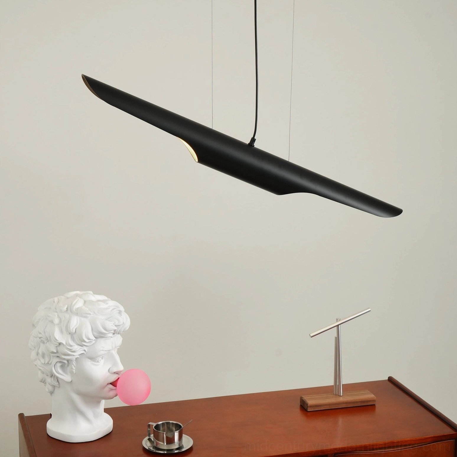 Contemporary linear pendant light profile showing sleek black tubular design and hanging cord
