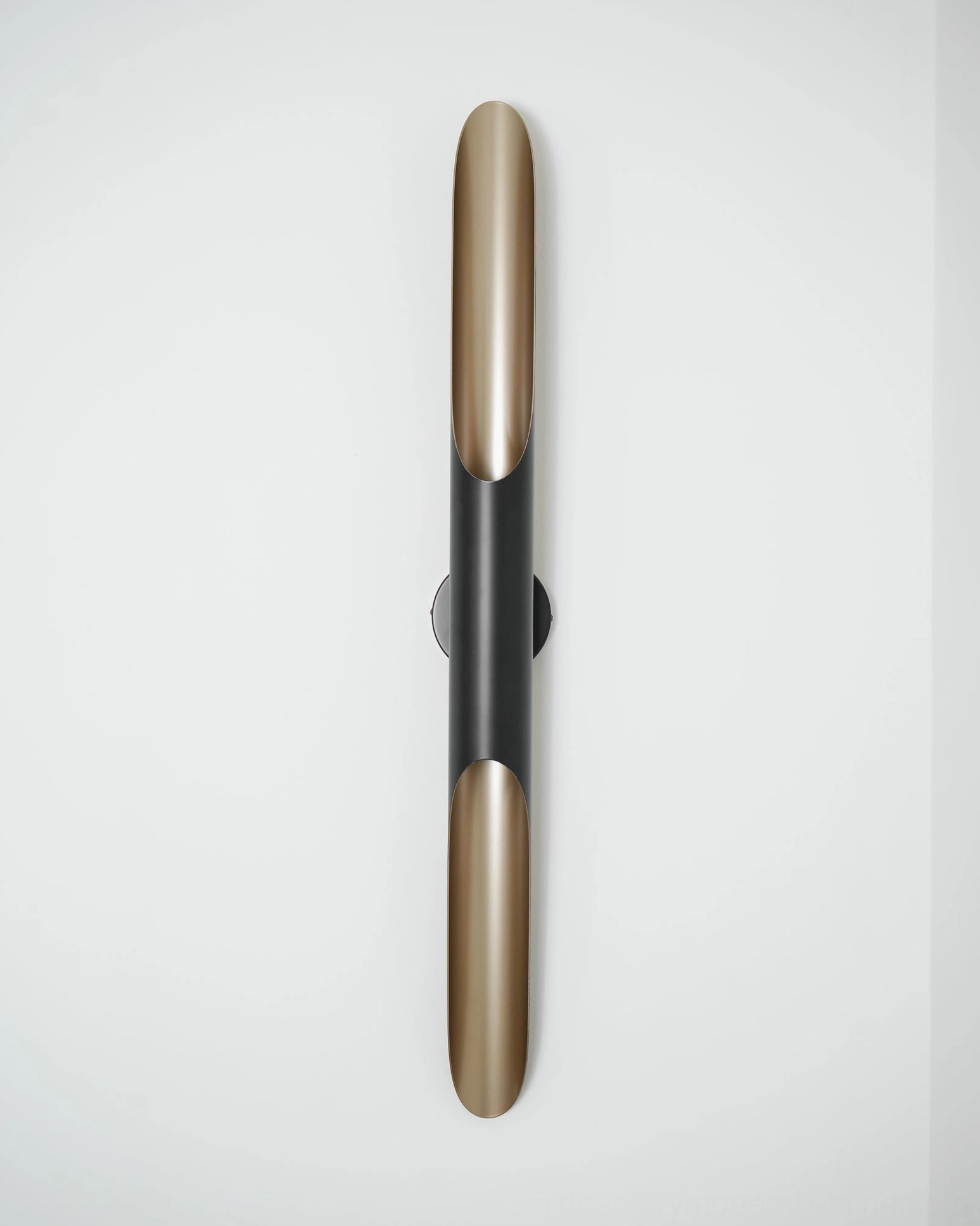 Coltrane wall lamp mounted on interior wall showcasing geometric form and shadow play lighting