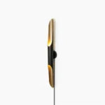 Coltrane linear wall sconce side view, matte black with brass gold accents minimalist design