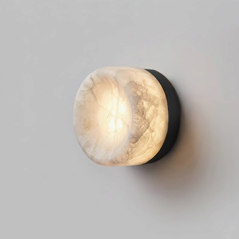 Compact size alabaster wall sconce installed as bathroom mirror accent light above pedestal sink vanity