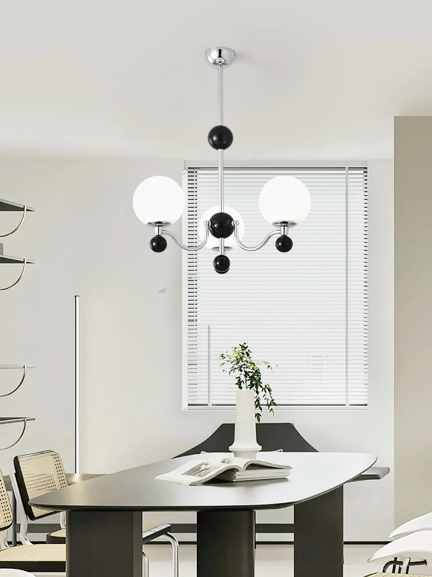 Compact three-head geometric chandelier in minimalist dining room with black white chrome color scheme