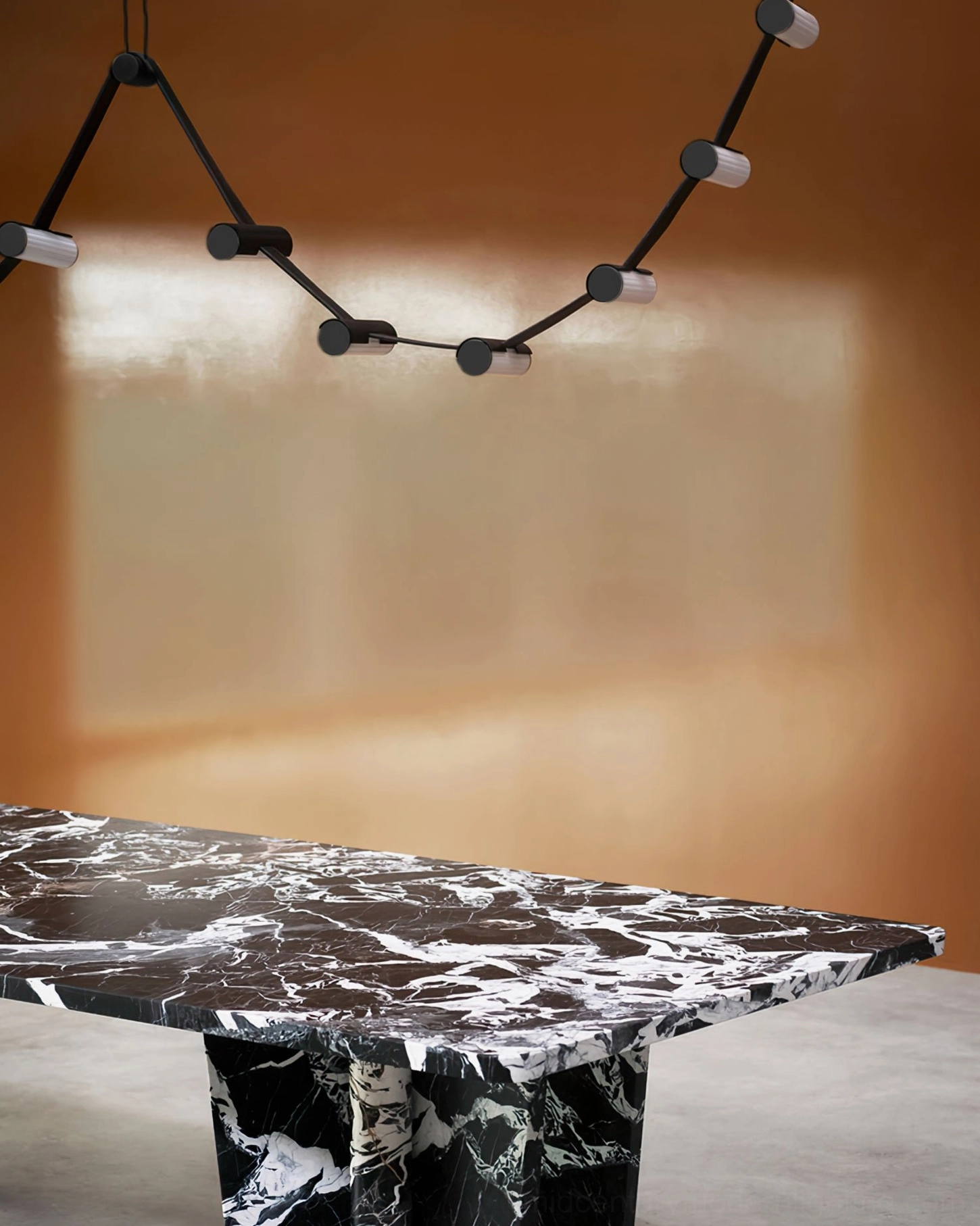 Mini wavy pendant chandelier over minimalist dining space with marble table, small-scale curved metal structure