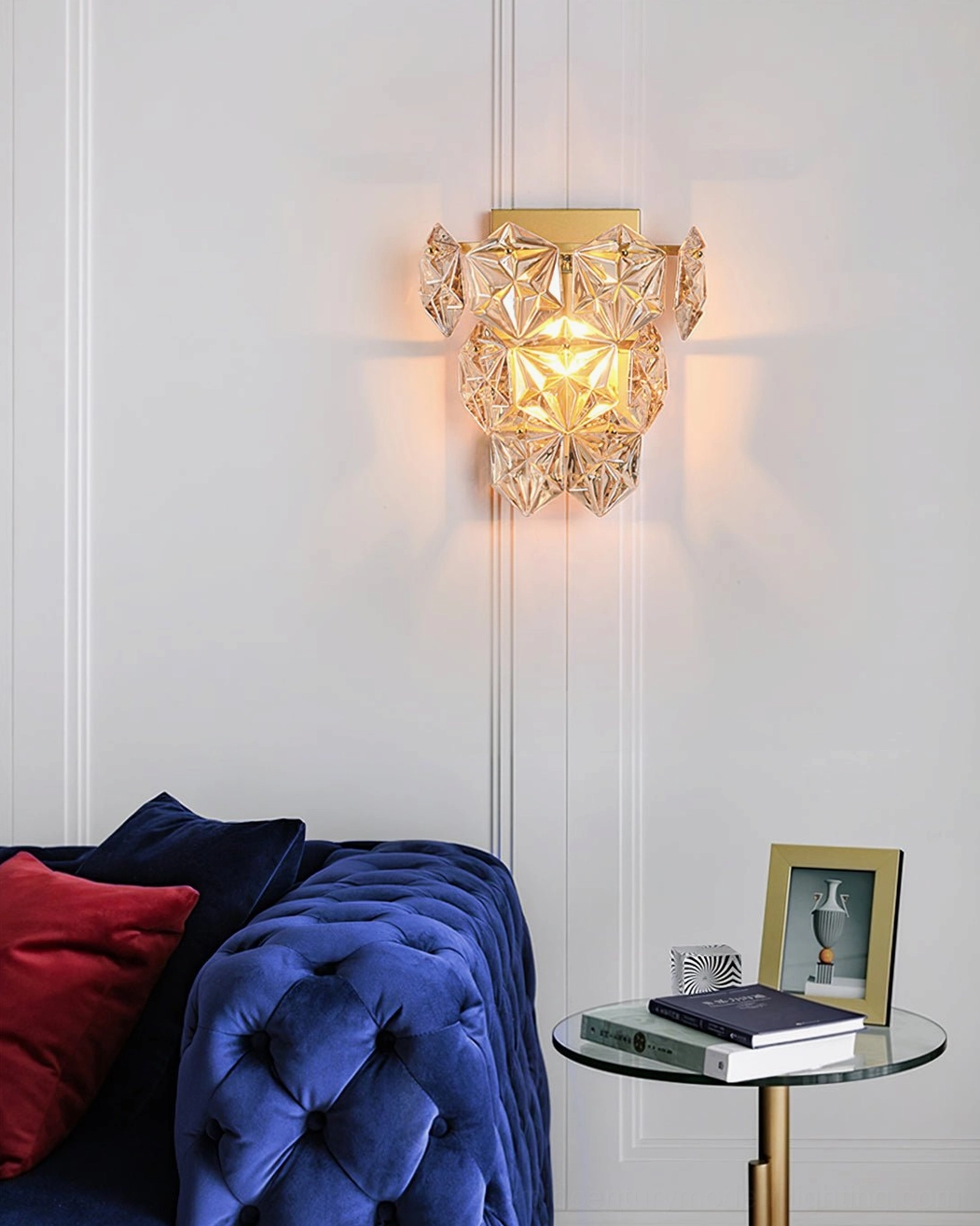 Compact modern crystal wall sconce with geometric facets mounted on living room accent wall