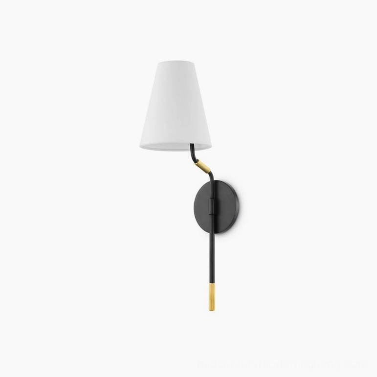Compact mid-century modern wall sconce with two-tone black and brass finish, studio lighting setup