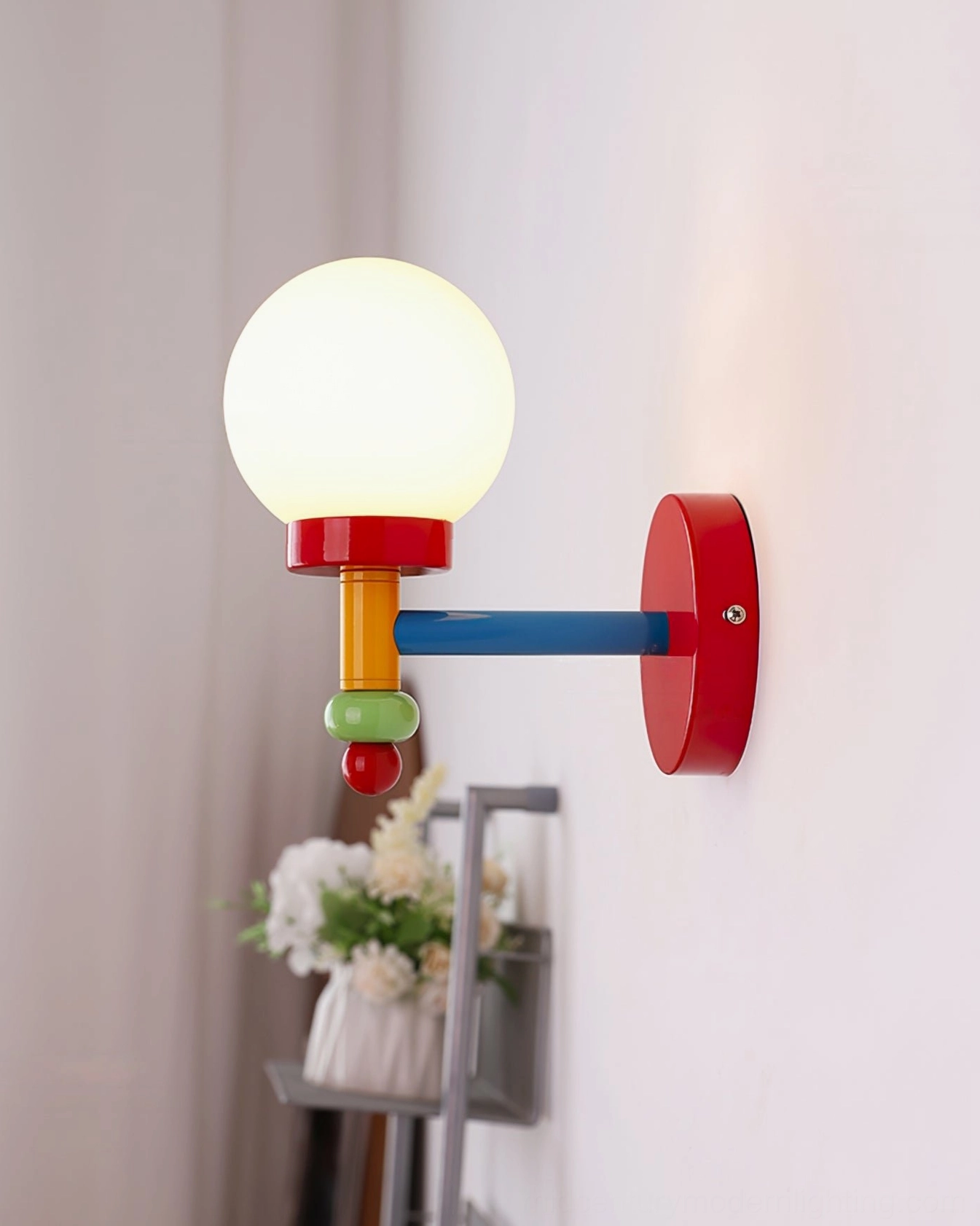 Compact modern wall light fixture with multicolor glass and metal construction detail view