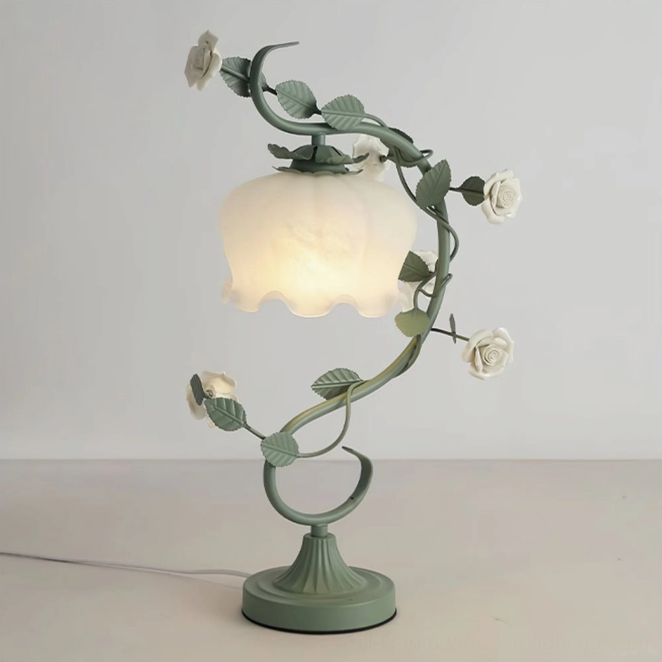 Complete sage green rose vine table lamp with frosted white ruffled shade in styled home setting
