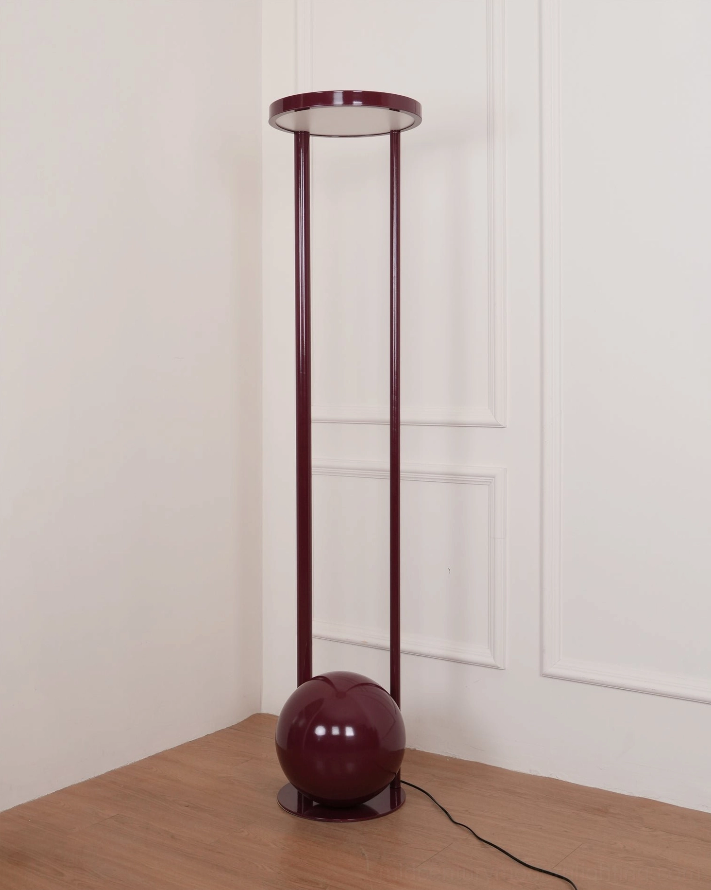 Burgundy composition floor lamp in modern corner ambient lighting - unlit with visible power cord on wood-paneled interior