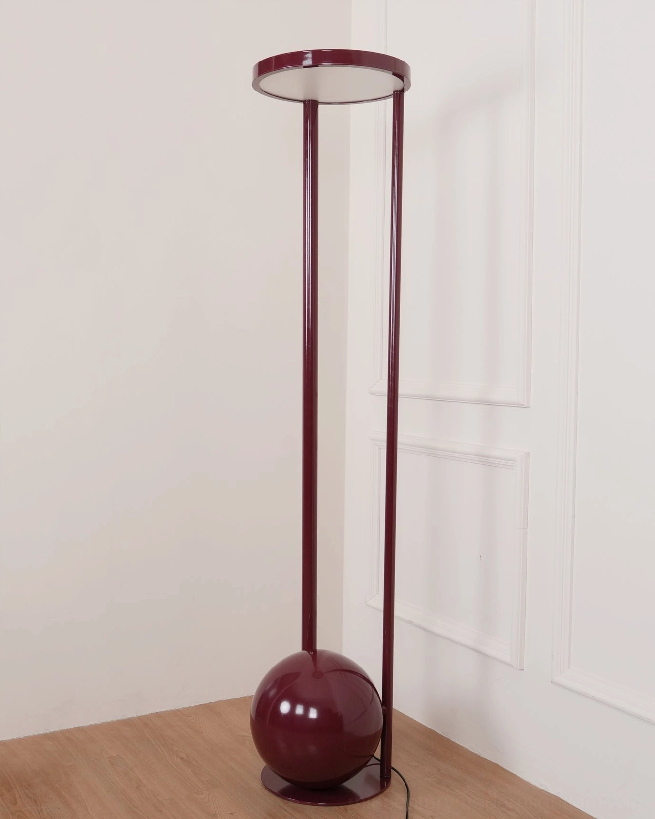 Composition red floor lamp right corner view - sculptural mid-century form with visible metal structure in contemporary paneled room