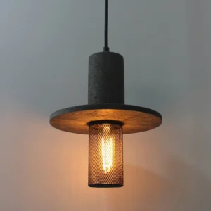 Close-up detail of Condo pendant light showing warm glowing Edison filament bulb through black diamond mesh diffuser and textured travertine finish