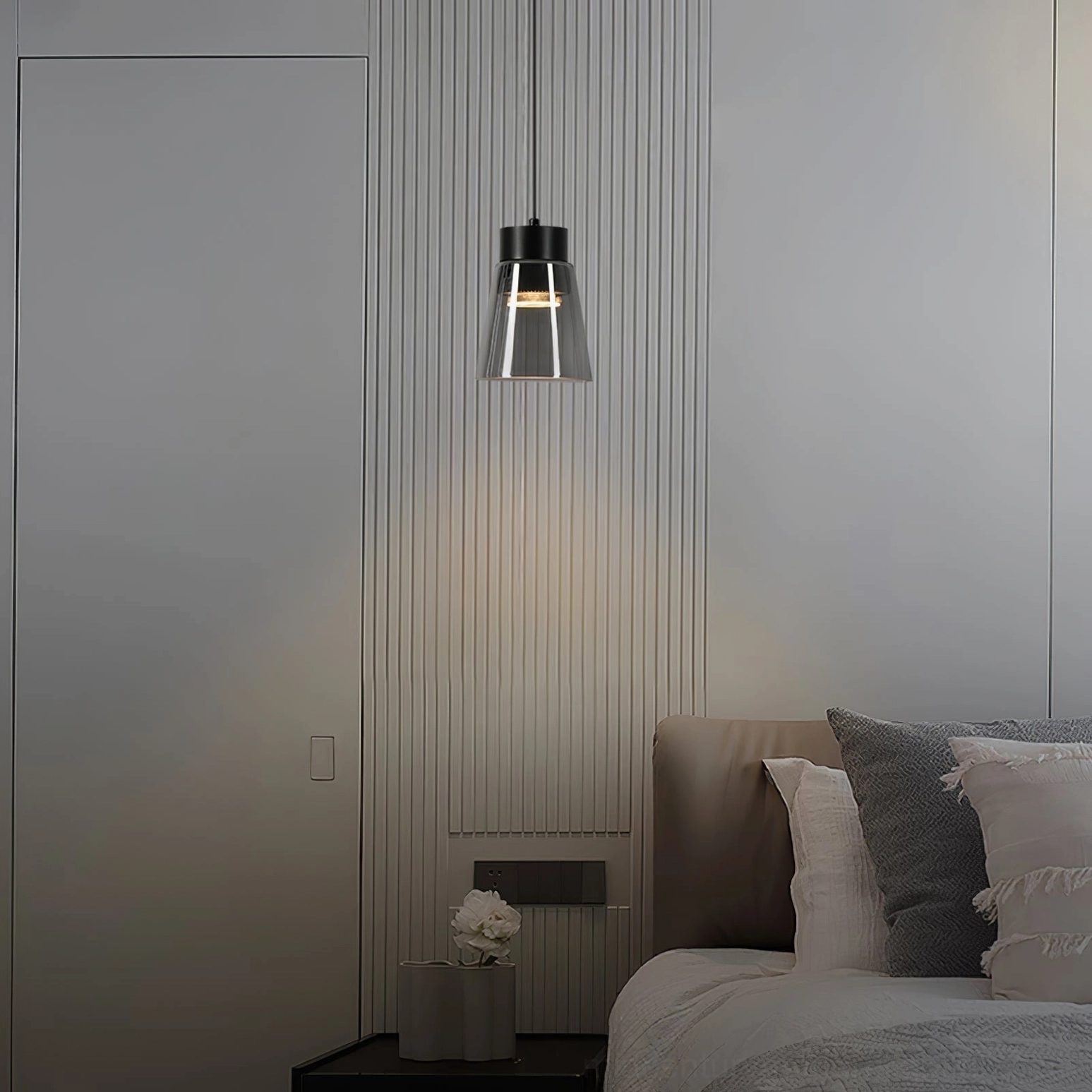 Modern smoke grey cone pendant with black hardware against bedroom accent wall