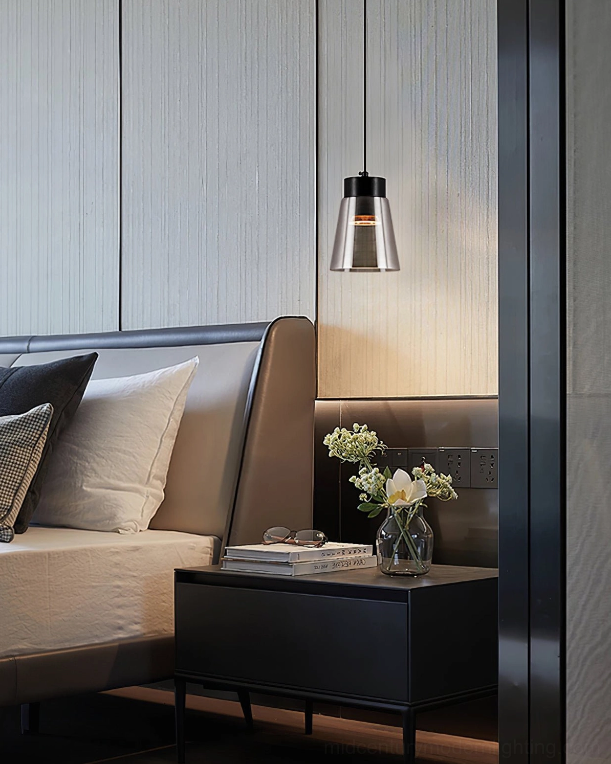 Smoke grey tapered pendant lamp over bedside table with warm lighting and nightstand decor